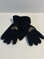 Top view of black fleece gloves showing embroidered Tiger-Cats logos