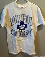 Front view of white Toronto Maple Leafs T-shirt on hanger
