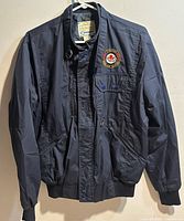 Front view of Canadian Warplane Heritage flight jacket showing patch, pockets, zipper and storm flap