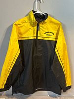 Front view of yellow and black Kenpo windbreaker on hanger