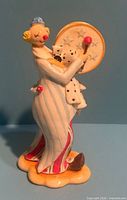 Front left view of porcelain clown figurine with tambourine