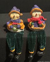 Front view of both snowman figurines showing torsos, hats, scarves, and fabric legs