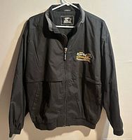 Front view of black Starter Hamilton Tiger-Cats 1999 Grey Cup Champions jacket showing full design