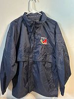 Front view of navy Stormtech windbreaker displaying embroidered Hamilton 2003 logo and full zip