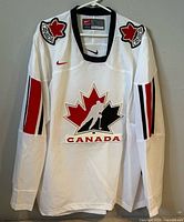 Front view of Nike Team Canada jersey showing crest, patches, sleeve stripes