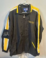 Front of black Tiger Cats Starter jacket showing chest logo, sleeve stripes and patch