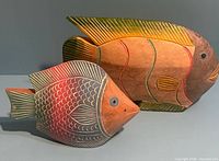Front view of both carved wooden fish figures