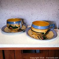Two cups on saucers side by side showing overall set