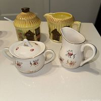 Both sugar and creamer sets displayed