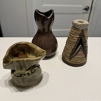 All three abstract studio pottery vases grouped together on countertop