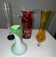 Group shot of four coloured glass vases