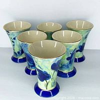 Six ceramic goblets grouped to show design