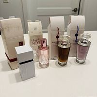 Group shot of four perfume bottles and respective boxes