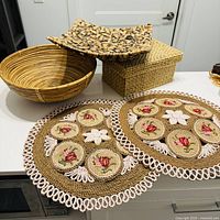All items laid out: rattan bowl, wood platter, raffia box, two placemats