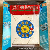 Front of boxed Dial To Learn Spelling toy showing product name and sealed packaging