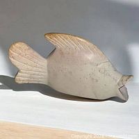 Left side view of cream soapstone fish carving