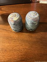 Both shakers front view on table