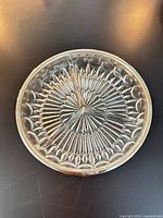 Top view of round divided glass dish showing sections and starburst pattern