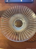 Top view of clear glass platter showing radial design