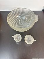 Overhead view of punch bowl with two handled cups