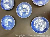 Five of the blue and white plates, various winter scenes visible