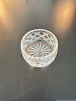 top view showing starburst interior and scalloped rim of small clear glass bowl