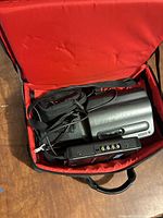 Camcorder, charger dock, bag interior showing accessories