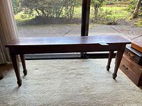 Full view of oak bench front profile showing legs and full length