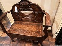 Front angle of carved oak hall bench