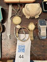 Overview of pendant, celluloid box and three watches