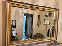 Front view of the framed mirror hanging on wall
