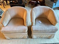 Front view of both cream velvet tub chairs