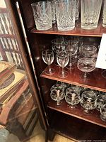 Cabinet view showing rocks glasses, stemmed wine glasses, coupes