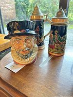 Toby jug and both German steins on table