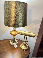 Both lamps on tabletop showing full forms and relative scale