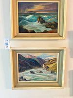 Both framed paintings hung vertically, showing overall size and matching frames