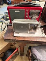 Both radios on table, Panasonic in foreground, Grundig behind