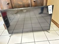 Front view of Samsung TV showing screen and stand