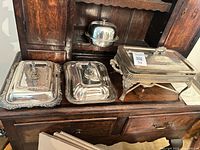 All four silver plate items on sideboard