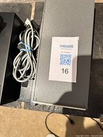 Grey slide storage box and coiled power cord