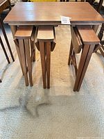 stand with three folded tables inside