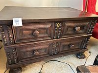 Front view showing four drawers, barley twist stiles and bun feet