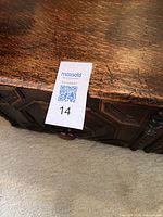 Front corner showing paneled carving and wear