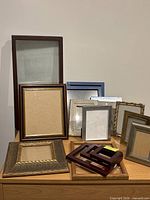 Frontal view of all eleven assorted frames displayed on cabinet
