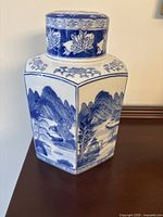 Front view showing blue landscape panels and hexagonal form