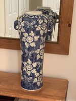 Front view of blue and white porcelain vase with floral motifs and elephant handles