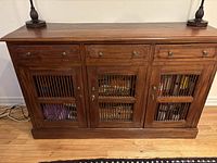 Front view showing entire console with drawers and spindle doors