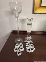 group shot of both glass candle holders and ten porcelain heart napkin rings