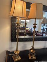 Full view of both gold-coloured lamps with shades