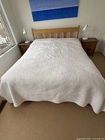 Front view of assembled queen bed with headboard visible